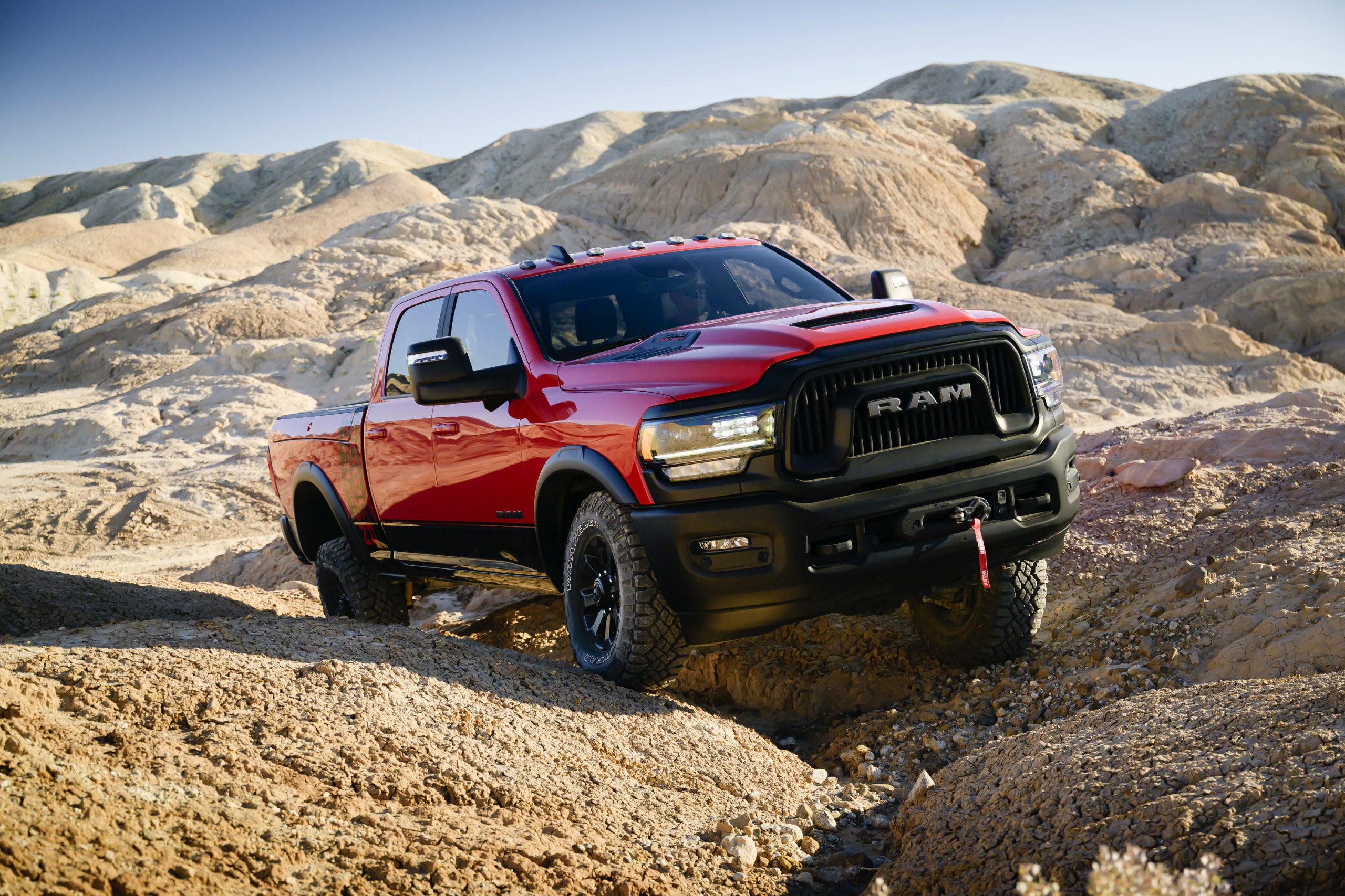 red RAM heavy duty truck climbing rocky landscape